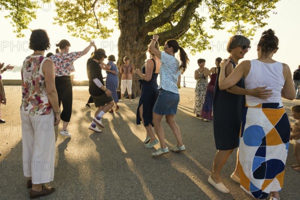People dancing in the sun, Promenade, Bregenz, Lake Constance, Vorarlberg, Austria