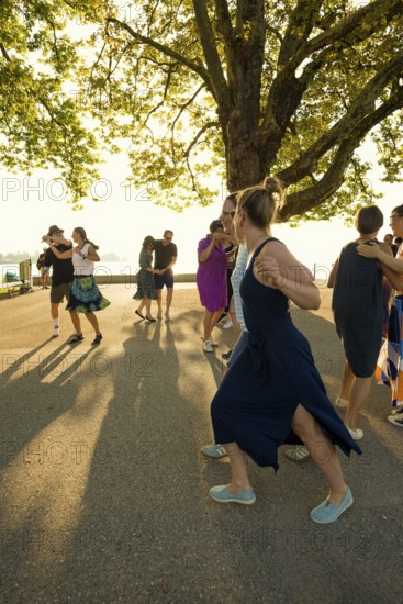 People dancing in the sun, Promenade, Bregenz, Lake Constance, Vorarlberg, Austria
