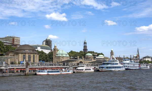 Elbe and boats at the St. Pauli piers, historic building with a level tower, in the back church tower of the church of St. Michaelis, Hamburg, Germany