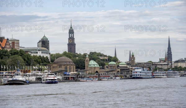 Elbe and boats at the St. Pauli piers, historic building with a level tower, in the back church tower of the church of St. Michaelis, Hamburg, Germany