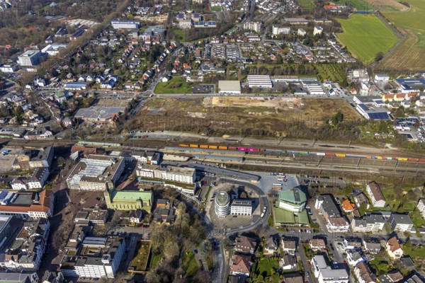 Aerial view, Unna railway station, Viktoriastrasse construction area for office building, St. Catherine's Catholic Church, Unna town hall, Unna, Ruhr area, North Rhine-Westphalia, Germany. Katharina, Unna town hall, Unna, Ruhr area, North Rhine-Westphalia, Germany, place of worship, railway station, Bahnhofstraße, station forecourt, construction area, building site, building plots, construction project, construction site, authority, bus station, container train, DE, Deutsche Bahn AG, development, Europe, religious community, house of worship, capacity requirement, church, parish, denomination, aerial view, aerial photography, aerial photography, new building, town hall, town hall square, religion, suburban railway, city administration, overview, administrative area, bird's-eye view, birds-eyes view, former Hildebrand plough factory, overview