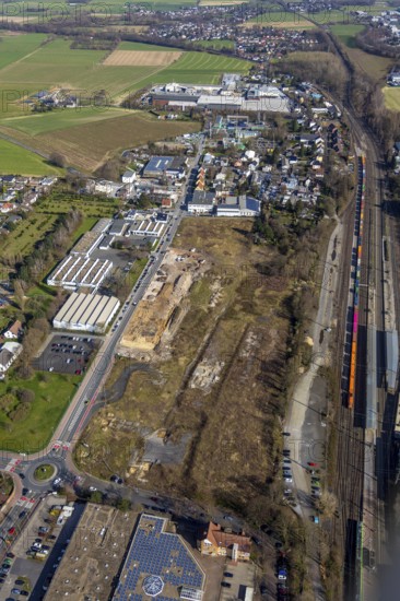 Aerial view, Unna railway station, Viktoriastrasse construction area for office building, Unna, Ruhr area, North Rhine-Westphalia, Germany, railway station, Bahnhofstrasse, station forecourt, construction area, construction site, building plots, construction project, construction site, bus station, container train, DE, Deutsche Bahn AG, development, Europe, capacity requirements, aerial view, aerial photography, aerial photography, new construction, S-Bahn, overview, bird's eye view, former Hildebrand plough factory, overview