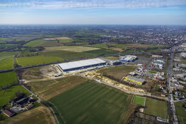 Aerial view, new Woolworth headquarters and logistics centre, commercial area Unna Kamen, Ikea, Unna, Ruhr area, North Rhine-Westphalia, Germany, A1 motorway, DE, Europe, commercial enterprises, commercial area, commercial park, commercial location, commercial use, freight traffic, industrial area, industrial location, logistics, logistics centre, aerial view, aerial photography, aerial photography, overview, bird's-eye view, meadows and fields, birds-eyes view, overview