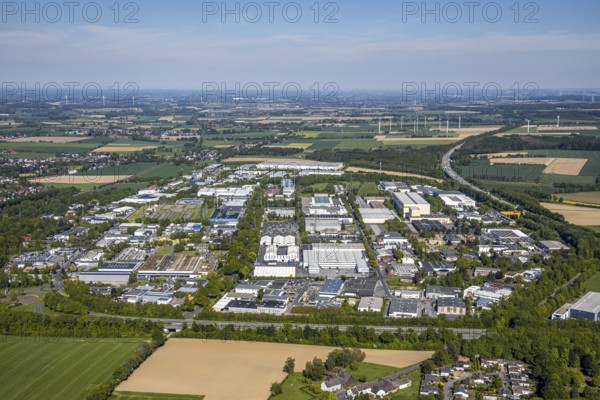 Aerial view, industrial park Unna-Ost, Unna, Ruhr area, North Rhine-Westphalia, Germany, motorway A44, DE, energy, Europe, distant view, commercial enterprises, commercial area, commercial park, commercial location, commercial use, industrial plants, industrial area, industrial location, aerial photograph, aerial photography, aerial photography, overview, bird's-eye view, WTG, meadows and fields, wind energy plant, wind power, wind turbine, wind farm, wind turbines, bird's-eye view, overview
