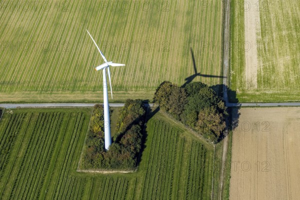 Aerial view, wind turbine in the field, Am Predigtstuhl, Unna, Ruhr area, North Rhine-Westphalia, Germany, DE, energy, energy industry, Europe, shapes and colours, green trees, aerial view, aerial photography, aerial photography, shadow casting, electricity, overview, bird's-eye view, WTG, meadows and fields, wind energy, wind turbine, wind power, wind turbine, wind wheels, birds-eyes view, overview