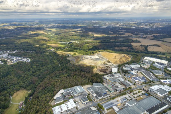 Aerial view, overburden dump Zechenweg, Hefel, industrial area Röbbeck, Stahlstraße, Röbbeck, Velbert, Ruhr area, North Rhine-Westphalia, Germany, overburden dump, motorway A44, motorway bridge, bridge, DE, Europe, distant view, commercial enterprises, commercial area, commercial area, commercial park, commercial site, commercial use, Hesperbach, industrial area, industrial site, aerial view, aerial photography, aerial photography, nature reserve, overview, bird's-eye view, forest area, birds-eyes view, onlyVelbert, overview, Velbert-Mitte