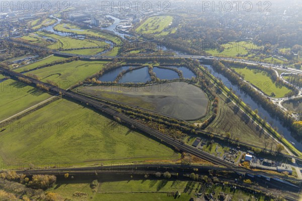 Aerial view, sewage sludge landfill at Styrumer Ruhrbogen, Ruhr meadows, river Ruhr, Mülheim an der Ruhr, Ruhr area, North Rhine-Westphalia, Germany, bridge over the Ruhr, DE, landfill, railway bridge, Europe, distant view, flood, aerial view, aerial photography, aerial photography, Ruhr floodplain, Ruhr valley cycle path, Ruhr riverbank, Speldorfer Straße, overview, bird's-eye view, wind turbine, wind energy, wind energy plant, wind power, wind turbine, wind turbines, birds-eyes view, overview, flooding