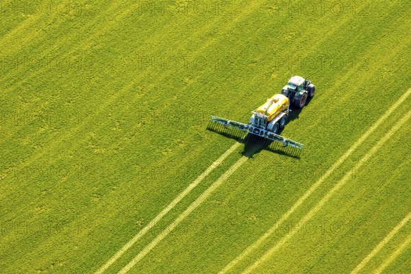 Aerial view, tractor with trailer working in the field, fertilising, Hellefeld, Sundern, Sauerland, North Rhine-Westphalia, Germany, DE, Europe, aerial view, aerial photography, aerial photography, overview, bird's-eye view, birds-eyes, view, overview, agriculture, harvest, harvest areas, cultivated areas
