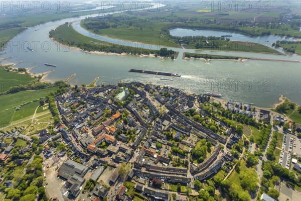 Aerial view, city centre view, catholic church St. Mariä Himmelfahrt, river Rhine, sports harbour Obermörmter, Reeser Schanz landscape protection area, shipping, Rees, Lower Rhine, North Rhine-Westphalia, Germany, place of worship, DE, Europe, religious community, place of worship, goods transport, goods traffic, harbour, church, parish, denomination, cargo ships, logistics, aerial view, aerial photography, aerial photography, religion, Rhine bend, shipping traffic, overview, bird's eye view, birds-eyes view, overview