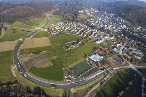 Aerial view, new construction of the bypass road L776n Bad Fredeburg, SauerlandBad, sports field, senior citizens' centre St.Raphael, Fredeburg, Schmallenberg, Sauerland, North Rhine-Westphalia, Germany, retirement home, old people's home, retirement home, bathing establishment, bathing resort, construction work, construction, construction area, building site, building plots, construction project, construction site, care and nursing, bridge, DE, relief of the through road, Europe, leisure activities, property tax, indoor swimming pool, real estate, state road L776n, aerial view, aerial photography, aerial photography, new construction, bypass, care facility, swimming pool, retirement home, retirement residence, retirement home, retirement centre, Stoppelhof, overview, bypass, bird's eye view, forest area, residential area, living and living, residential area, residential buildings, quality of life, birds-eyes view, overview