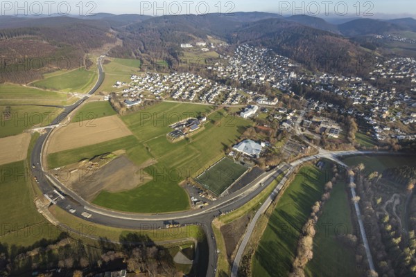 Aerial view, new construction of the bypass road L776n Bad Fredeburg, SauerlandBad, sports field, senior citizens' centre St.Raphael, Fredeburg, Schmallenberg, Sauerland, North Rhine-Westphalia, Germany, retirement home, old people's home, retirement home, bathing establishment, bathing resort, construction work, construction, construction area, building site, building plots, construction project, construction site, care and nursing, bridge, DE, relief of the through road, Europe, leisure activities, property tax, indoor swimming pool, real estate, state road L776n, aerial view, aerial photography, aerial photography, new construction, bypass, care facility, swimming pool, retirement home, retirement residence, retirement home, retirement centre, Stoppelhof, overview, bypass, bird's eye view, forest area, residential area, living and living, residential area, residential buildings, quality of life, birds-eyes view, overview