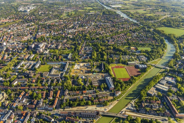 Aerial view, view of St. Mauritz, construction site of new Mathilde-Anneke comprehensive school, sports field Sportclub Münster 08, Dortmund-Ems canal, Münster, Münsterland, North Rhine-Westphalia, Germany, Albert-Schweitzer-Schule Münster, construction, construction area, construction site, building plots, construction project, construction site, education, educational institution, DE, Europe, football pitch, football stadium, football club, comprehensive school, Hans-Böckler-Berufskolleg, canal, canal bridge, educational institute, aerial view, aerial photography, aerial photography, new building, school, sports, sports facilities, sports field, sports facility, overview, bird's-eye view, birds-eyes view, overview