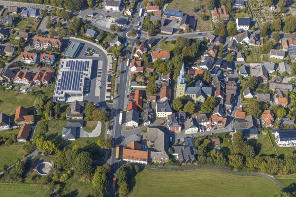 Aerial view, local view, St. Stephanus Kirche, Oestinghausen, Lippetal, Kreis Soest, North Rhine-Westphalia, Germany, Aldi Supermarkt Neubau, Andachtstätte, DE, Europe, Glaubensgemeinschaft, Gotteshaus, Grundsteuer, Immobilien, Innenstadt, Kirche, Kirchengemeinde, Konfession, Kreis-Soest-Buch, KreisSoestBuch, Kreisverkehr, aerial view, aerial photography, aerial photography, photovoltaic, photovoltaic system, religion, solar, solar system, solar energy, solar energy, city centre, overview, bird's-eye view, residential area, residential buildings, residential quality, residential quarter, housing estate, birds-eyes view, overview