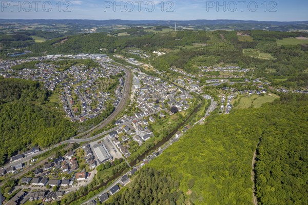 Aerial view, view of Meggen, Lennestadt-Meggen railway station, Rayonex Biomedical GmbH, Franziskus-Schule Meggen, DITIB Yesil Mosque Lennestadt, Catholic Church St. Bartholomäus, Meggen, Lennestadt, Sauerland, North Rhine-Westphalia, Germany, place of worship, railway tracks, railway station, burial site, education, educational institution, DE, Deutsche Bahn AG, Europe, distant view, cemetery, Meggen cemetery, Schützenhof restaurant, memorial, religious community, churchyard, place of worship, property tax, cemetery, hilly landscape, real estate, church, parish, denomination, educational institution, aerial view, aerial photography, aerial photography, resting place, school, overview, bird's-eye view, housing estate, living and life, residential area, residential buildings, residential quality, housing estate, birds-eyes view, overview, wladg