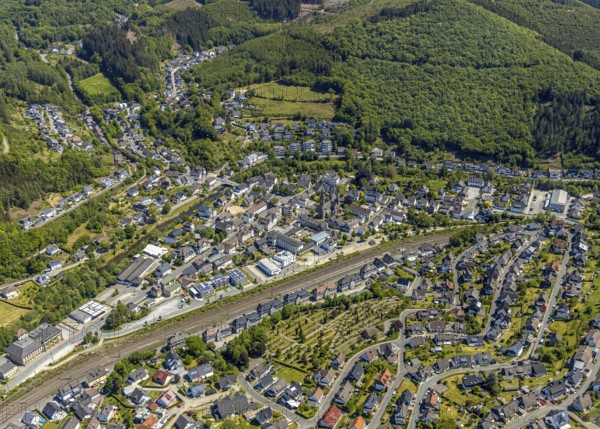 Aerial view, view of Meggen, Lennestadt-Meggen railway station, Rayonex Biomedical GmbH, Franziskus-Schule Meggen, DITIB Yesil Mosque Lennestadt, Catholic Church St. Bartholomäus, Lennestadt, Sauerland, North Rhine-Westphalia, Germany, place of worship, railway tracks, railway station, burial site, education, educational institution, DE, Deutsche Bahn AG, Europe, cemetery, Meggen cemetery, Schützenhof restaurant, memorial, religious community, place of worship, place of worship, property tax, cemetery, real estate, church, parish, denomination, educational institution, aerial view, aerial photography, aerial photography, resting place, school, overview, bird's-eye view, housing estate, housing and living, residential area, residential buildings, housing quality, housing estate, birds-eyes view, overview, wladg
