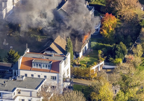 Several callers reported a fire with heavy smoke on Bergerstraße in Mülheim-Menden at 2.57 pm today, Saturday. When the first emergency services arrived, they discovered that the roof truss of a two-storey residential building was fully engulfed in flames. Due to the expected long and intensive operation, a full alarm was immediately sounded for the volunteer fire brigade. There were no residents in the house. Firefighters from the professional fire brigade immediately began fighting the fire from the inside and using a turntable ladder. As the operation progressed, they were supported by colleagues from the Heißen fire brigade of the volunteer fire brigade. Once the actual fire had been extinguished, the post-extinguishing work proved to be quite complex and lengthy. Parts of the roof have to be removed in order to reach any remaining embers. The ongoing operation involved two fire engines, several special and command vehicles from the professional fire brigade as well as vehicles fro...