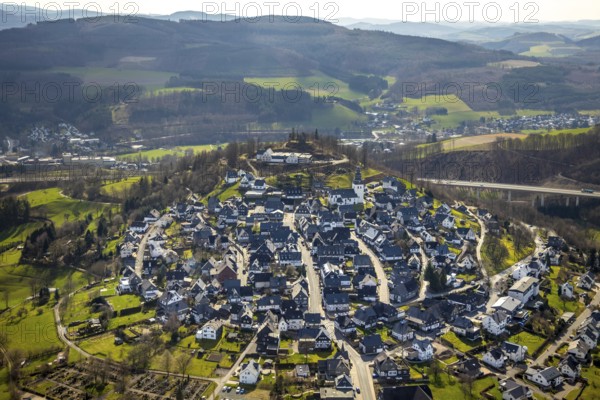 Aerial view, view of Eversberg, ruins of Eversberg Castle, Schlossberghalle Eversberg, St.-Johannes-Evangelist-Kirche, Eversberg, Meschede, Sauerland, North Rhine-Westphalia, Germany, castle, DE, Europe, half-timbered houses, religious community, place of worship, property tax, hilly landscape, real estate, church, parish, denomination, aerial view, aerial photography, aerial photography, Arnsberg Forest nature park Park, religion, ruins, castle, castle hill, overview, event location, event venue, bird's-eye view, meadows and fields, residential area, living and life, residential area, residential buildings, residential quality, residential neighbourhood, housing estate, bird's-eye view, cultural use, overview
