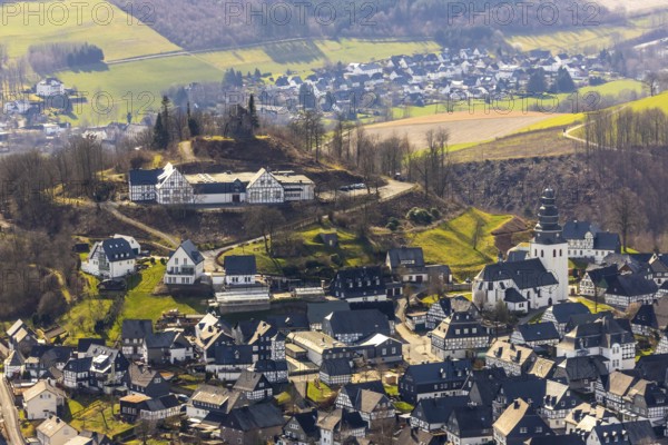 Aerial view, view of Eversberg, Eversberg Castle ruins, Eversberg Castle Hall, St.Johannes-Evangelist-Kirche, Eversberg, Meschede, Sauerland, North Rhine-Westphalia, Germany, castle, DE, Europe, half-timbered houses, religious community, place of worship, property tax, real estate, church, parish, denomination, aerial view, aerial photography, aerial photography, Arnsberg Forest nature park Park, religion, ruins, castle, castle hill, overview, event location, event venue, bird's-eye view, meadows and fields, residential area, housing and living, residential area, residential buildings, residential quality, residential neighbourhood, housing estate, bird's-eye view, cultural use, overview