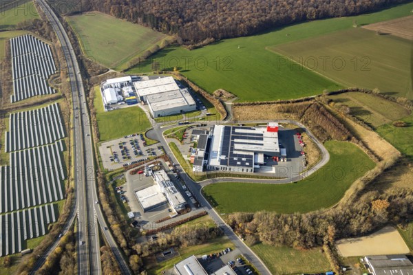 Aerial view, industrial estate Enste-Nord, Maschinenbau SH Anbaugeräte GmbH, Enste, Meschede, Sauerland, North Rhine-Westphalia, Germany, motorway A46, motorway junction Enste, DE, Europe, commercial enterprises, commercial area, commercial area, commercial park, commercial location, commercial use, industrial area, industrial location, aerial view, aerial photography, aerial photography, photovoltaics, photovoltaic system, solar, solar system, solar energy, solar park Enste, overview, bird's-eye view, bird's-eye view, overview
