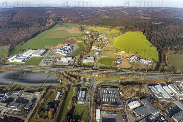 Aerial view, industrial estate Enste-Nord, Enste, Meschede, Sauerland, North Rhine-Westphalia, Germany, motorway A46, motorway junction Enste, DE, Europe, commercial enterprises, commercial area, industrial estate, business park, commercial location, commercial use, industrial area, industrial location, aerial photograph, aerial photography, aerial photography, photovoltaics, photovoltaic system, solar, solar system, solar energy, solar park Enste, overview, bird's-eye view, birds-eyes view, overview