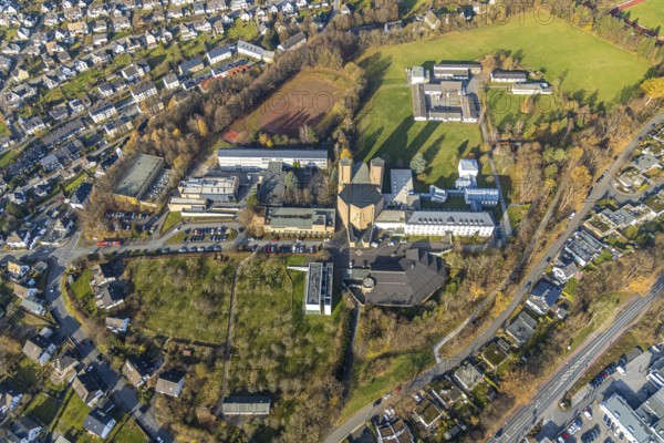 Aerial view, Königsmünster Abbey with Benedictine grammar school, House of Silence, Klosterberg, Meschede town, Meschede, Sauerland, North Rhine-Westphalia, Germany, abbey, place of worship, education, educational institution, DE, Europe, religious community, House of God, grammar school, holy place, church, parish, monastery, denomination, aerial view, aerial photography, aerial photography, religion, religious site, school, sports field, towers, overview, bird's-eye view, forest area, birds-eyes view, catholic church, church of the Assumption of the Blessed Virgin Mary Church of the Assumption of the Virgin Mary Meschede, overview