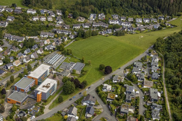 Aerial view, grammar school of the city of Meschede, meadow area Schederweg, planned building area near Menzelweg, Meschede, Sauerland, Hochsauerlandkreis, North Rhine-Westphalia, Germany, building area, building site, building plots, building project, education, educational institution, DE, Europe, property tax, grammar school, real estate, capacity requirements, educational institute, aerial view, aerial photography, aerial photography, Mescheder Höhenwanderweg, Schederweg, school, overview, bird's-eye view, forest area, meadows and fields, housing estate, living and life, residential area, residential buildings, residential quality, residential neighbourhood, housing estate, birds-eyes view, overview