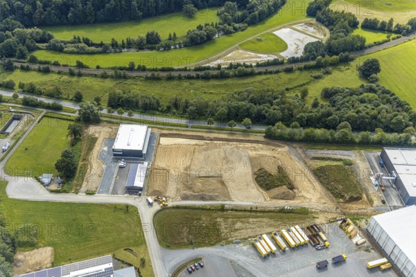 Aerial view, construction site new building Lausberg Kunststofftechnik, industrial estate Meschede-Enste, Am Heerweg, Meschede, Sauerland, Hochsauerlandkreis, North Rhine-Westphalia, Germany, construction work, construction area, building site, building plots, construction project, construction site, Caritas-Werkstätten Meschede, DE, Europe, commercial enterprises, commercial area, commercial park, commercial site, commercial use, industrial area, industrial site, L743 state road, Lausberg, Lausberg Kunststofftechnik, aerial photograph, aerial photography, aerial photography, MÖNIG Spedition, new building, R.A.B.E. waste processing, overview, bird's-eye view, birds-eyes view, overview