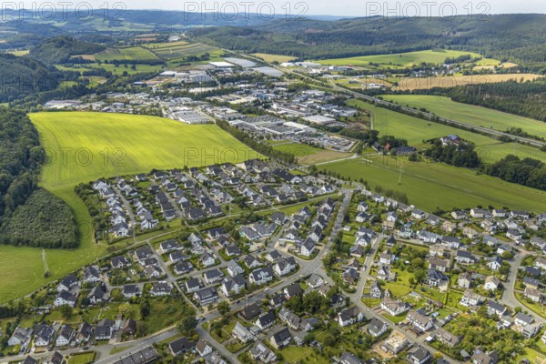 Aerial view, residential area Hückeler Höhe, commercial area Meschede-Enste, Hainberg landscape conservation area, Meschede, Sauerland, Hochsauerlandkreis, North Rhine-Westphalia, Germany, motorway A46, DE, Europe, distant view, commercial enterprises, commercial area, commercial park, commercial location, commercial use, property tax, hilly landscape, real estate, industrial area, industrial site, kindergarten, kindergarten Kleine Wolke, crèche, day nursery, day care centre, day nursery, landscape conservation area, aerial view, aerial photography, aerial photography, overview, bird's-eye view, woodland, meadows and fields, residential area, housing and living, residential area, residential buildings, residential quality, residential quarter, housing estate, birds-eyes view, overview