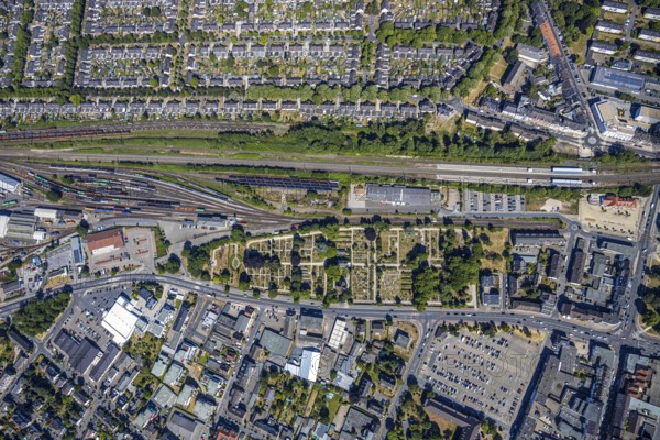 Aerial view, centre of Mörs, former goods station, railway tracks, cemetery Mörs, miners' settlement Moseler Straße, Lippestraße, Marienburger Straße, backyard, allotment gardens, historic miners' settlement, Meerbeck, Mörs, Ruhr area, North Rhine-Westphalia, Germany, DE, Europe, birds-eyes, view, aerial view, aerial photography, aerial photography, overview, overview, bird's-eye view, living, flat, houses, residential buildings, housing estate, settlement, railway line, railway network, infrastructure, traffic, train traffic, freight traffic, railway network, funeral, burial, funeral service, farewell, green area, mourning, green space, commemoration