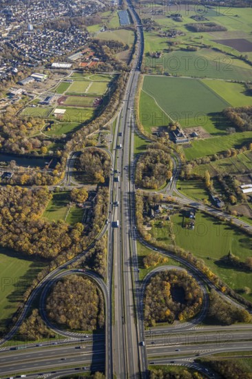 Aerial view, motorway junction Mörs, A40, A57, Moers-Hülsdonk, Mörs, Ruhr area, North Rhine-Westphalia, Germany, motorway A40, motorway A57, motorway junction, DE, Europe, shapes and colours, green trees, autumn colours, aerial view, aerial photography, aerial photography, overview, bird's-eye view, overview
