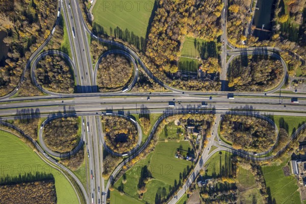 Aerial view, motorway junction Mörs, A40, A57, Moers-Hülsdonk, Mörs, Ruhr area, North Rhine-Westphalia, Germany, motorway A40, motorway A57, motorway junction, DE, Europe, shapes and colours, green trees, autumn colours, aerial view, aerial photography, aerial photography, overview, bird's-eye view, overview
