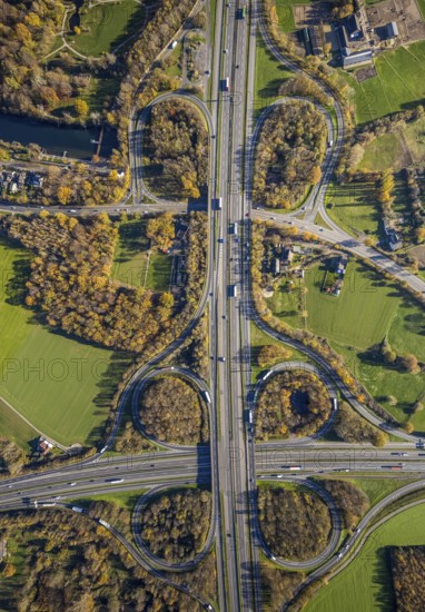 Aerial view, motorway junction Mörs, A40, A57, Moers-Hülsdonk, Mörs, Ruhr area, North Rhine-Westphalia, Germany, motorway A40, motorway A57, motorway junction, DE, Europe, shapes and colours, green trees, autumn colours, aerial view, aerial photography, aerial photography, overview, bird's-eye view, overview