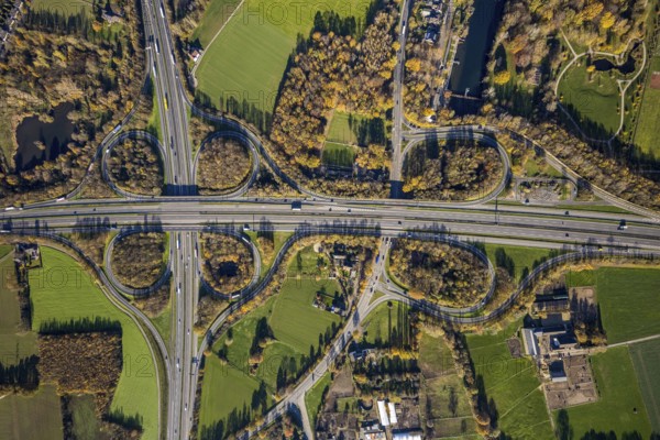 Aerial view, motorway junction Mörs, A40, A57, Moers-Hülsdonk, Mörs, Ruhr area, North Rhine-Westphalia, Germany, motorway A40, motorway A57, motorway junction, DE, Europe, shapes and colours, green trees, autumn colours, aerial view, aerial photography, aerial photography, overview, bird's-eye view, overview