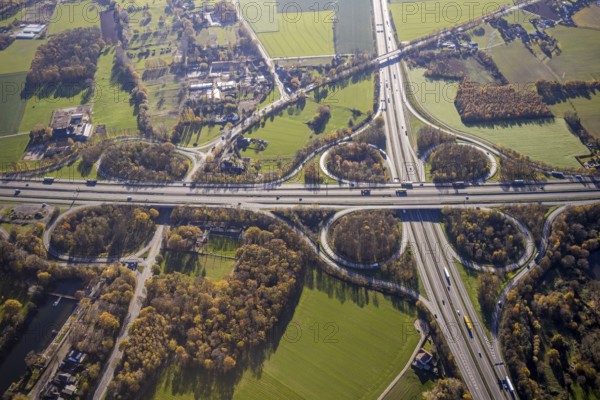 Aerial view, motorway junction Mörs, A40, A57, Moers-Hülsdonk, Mörs, Ruhr area, North Rhine-Westphalia, Germany, motorway A40, motorway A57, motorway junction, DE, Europe, shapes and colours, green trees, autumn colours, aerial view, aerial photography, aerial photography, overview, bird's-eye view, overview