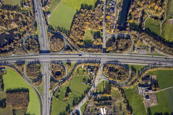Aerial view, motorway junction Mörs, A40, A57, Moers-Hülsdonk, Mörs, Ruhr area, North Rhine-Westphalia, Germany, motorway A40, motorway A57, motorway junction, DE, Europe, shapes and colours, green trees, autumn colours, aerial view, aerial photography, aerial photography, overview, bird's-eye view, overview