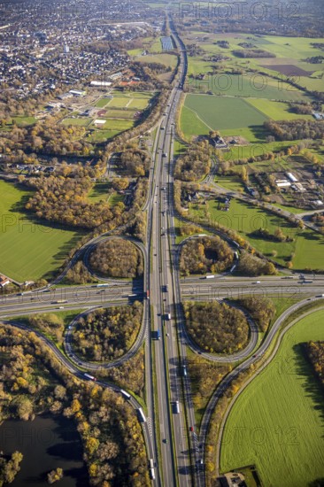 Aerial view, motorway junction Mörs, A40, A57, Moers-Hülsdonk, Mörs, Ruhr area, North Rhine-Westphalia, Germany, motorway A40, motorway A57, motorway junction, DE, Europe, shapes and colours, green trees, autumn colours, aerial view, aerial photography, aerial photography, overview, bird's-eye view, overview