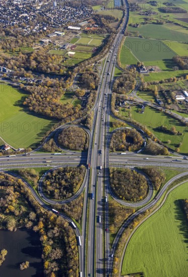 Aerial view, motorway junction Mörs, A40, A57, Moers-Hülsdonk, Mörs, Ruhr area, North Rhine-Westphalia, Germany, motorway A40, motorway A57, motorway junction, DE, Europe, shapes and colours, green trees, autumn colours, aerial view, aerial photography, aerial photography, overview, bird's-eye view, overview