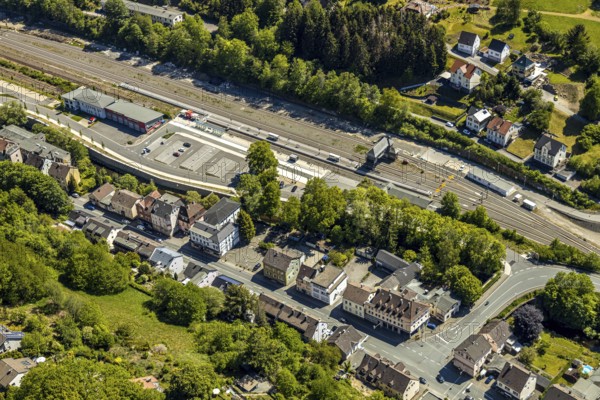 Aerial view, Brügge district, Lüdenscheid-Brügge railway station, Lüdenscheid fire brigade, Brügge equipment depot, Lüdenscheid, Märkischer Kreis, Sauerland, North Rhine-Westphalia, Germany, railway tracks, railway station, station forecourt, fire fighters, fire protection, fire watch, bridge signal box, federal road B54, DE, Deutsche Bahn AG, Europe, distant view, fire-fighting train, fire station, fire brigade, fire engine, commercial area, commercial use, property tax, green trees, real estate, district town, aerial view, aerial photography, aerial photography, fire-fighting train, tenement houses, separation station, overview, bird's eye view, Volmetal railway, living and life, residential buildings, birds-eyes view, green lung, overview