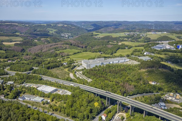Aerial view, Leopold Kostal GmbH & Co. KG, An der Bellmerei, motorway A45, Lüdenscheid, Märkischer Kreis, Sauerland, North Rhine-Westphalia, Germany, motorway, DE, Europe, distant view, commercial area, commercial use, industrial plants, industrial area, industrial site, Kostal, aerial photograph, aerial photography, aerial photography, car parks, production plants, production halls, overview, traffic, bird's-eye view, forest area, birds-eyes view, overview