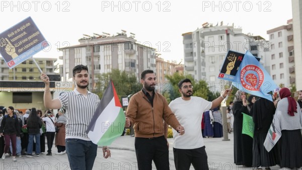 Gaziantep, Türkiye – October 11, 2025: Children and women wearing keffiyehs and carrying Palestinian flags and banners in support of Gaza participate in a massive rally following the announcement of a ceasefire, the withdrawal of Israeli forces, and a prisoner exchange between Hamas and Israel, Gaziantep, Türkiye