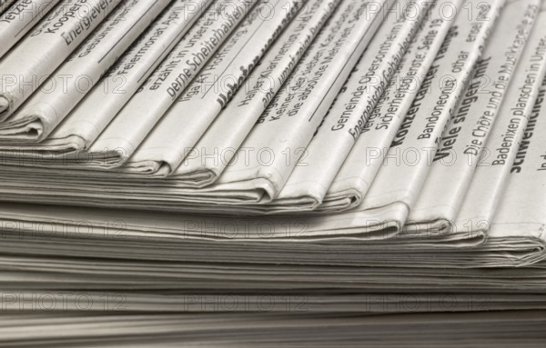Full frame background with lots of stacked newspapers