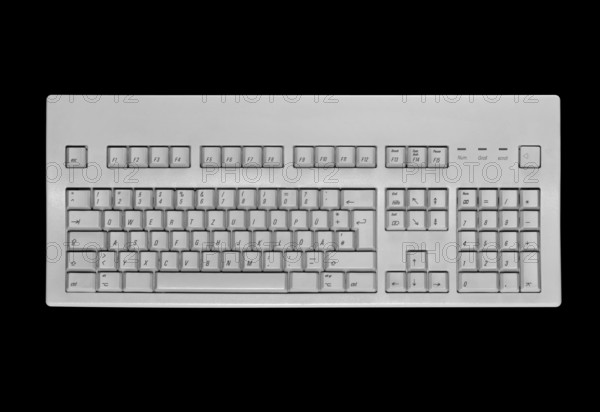 Studio photography of a grey keypad in black back, seen from above