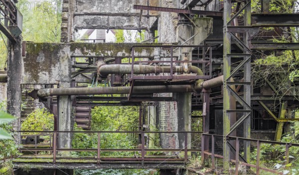 Weathered rundown industrial scenery with old corroded steel girders and metal tubes