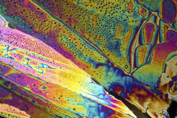Colorful microscopic shot of Sodium acetate micro crystals in polarized light