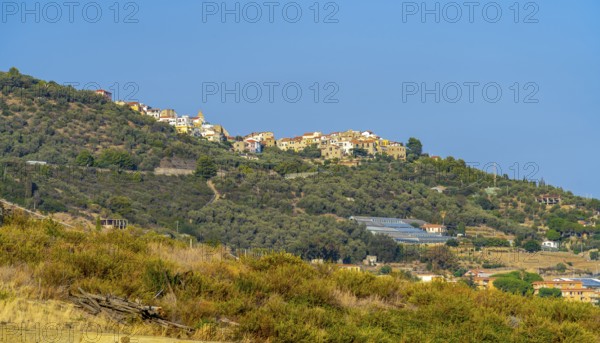 Small village on hill top seen in Liguria, Italy