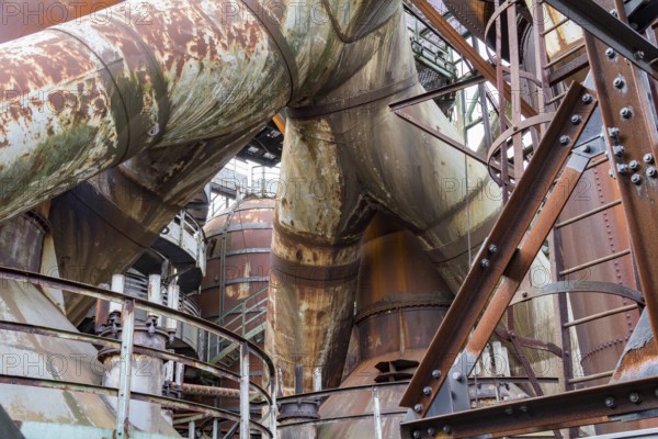 Weathered rusty industrial scenery with old corroded steel girders and metal tubes