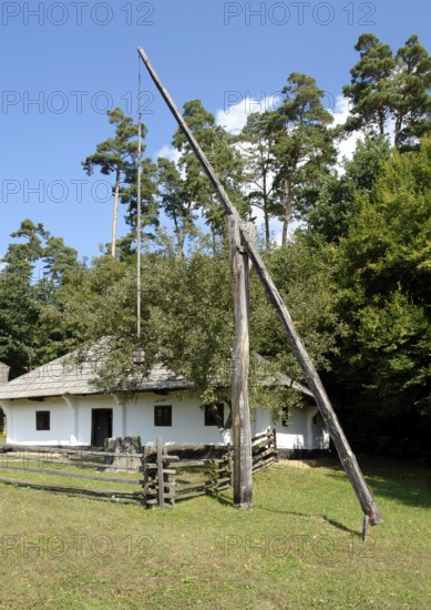Idyllic rural scenery including a historic standpost in Romania