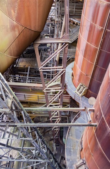 Weathered rusty high angle industrial scenery with old corroded steel girders and metal tubes