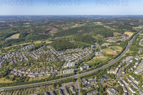 Aerial view, motorway A46, stadium Kirchenberg, residential area Im Sonnenwinkel, Hagen-Hohenlimburg, Ruhr area, North Rhine-Westphalia, Germany, DE, Europe, distant view, football pitch, football stadium, commercial enterprises, commercial area, commercial area, commercial location, commercial use, property tax, real estate, industrial area, industrial location, aerial view, aerial photography, aerial photography, sports, sports facilities, sports field, sports facility, overview, bird's-eye view, forest area, living and working, living and life, residential area, residential buildings, residential quality, housing estate, birds-eyes view, overview