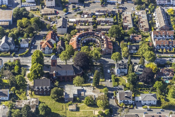 Aerial view, round building, residential building Eppenhauser Straße 160, DreifaltigkeitsKirche, Emst, Hagen, Ruhr area, North Rhine-Westphalia, Germany, place of worship, DE, Europe, place of worship, property tax, green trees, real estate, church, parish, denomination, aerial photograph, aerial photography, aerial photography, overview, bird's eye view, residential complex, living and life, residential area, residential buildings, quality of life, housing estate, birds-eyes view, overview